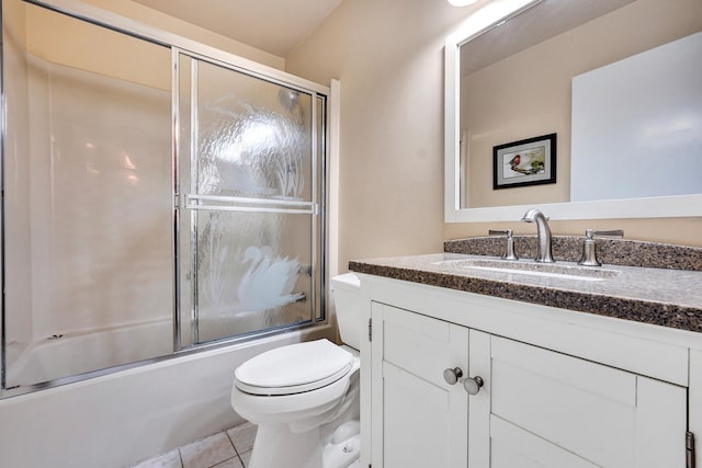 full bathroom with tile patterned flooring, vanity, toilet, and enclosed tub / shower combo