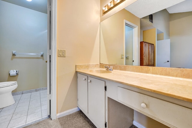 bathroom featuring tile patterned floors, vanity, and toilet