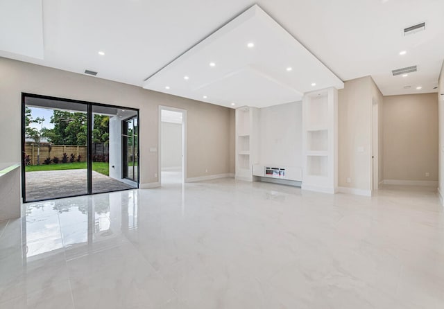 unfurnished living room featuring built in shelves