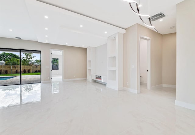 unfurnished living room with built in shelves and a notable chandelier