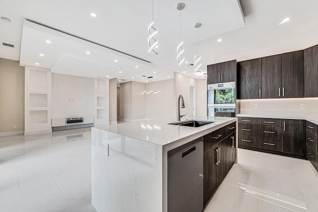 kitchen with sink, hanging light fixtures, stainless steel appliances, a center island with sink, and light tile patterned floors