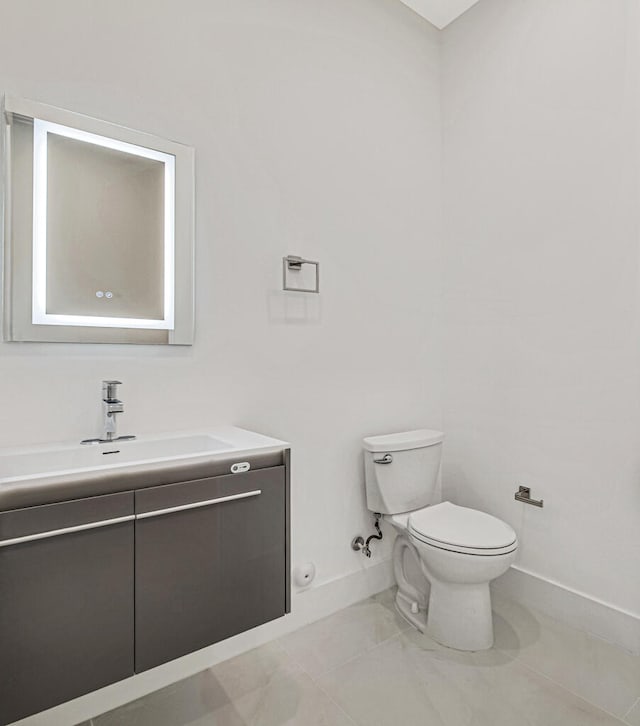 bathroom featuring tile patterned flooring, vanity, and toilet