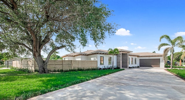 view of front of home featuring a front yard and a garage