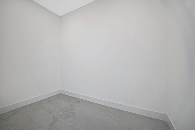 empty room with light tile patterned floors