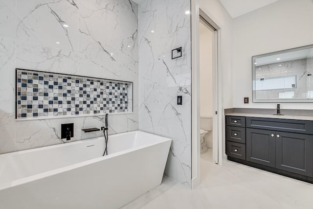 bathroom with a washtub, toilet, tile walls, and vanity