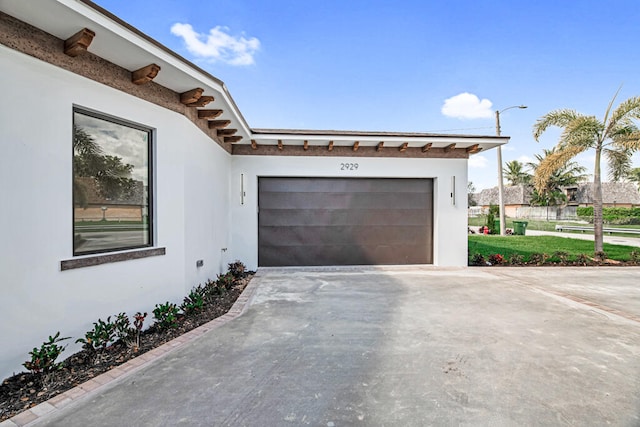 garage featuring a lawn