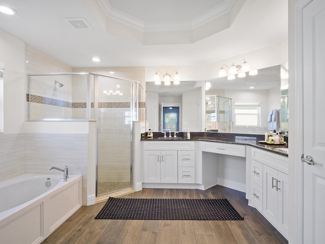 bathroom with vanity, wood-type flooring, ornamental molding, and plus walk in shower