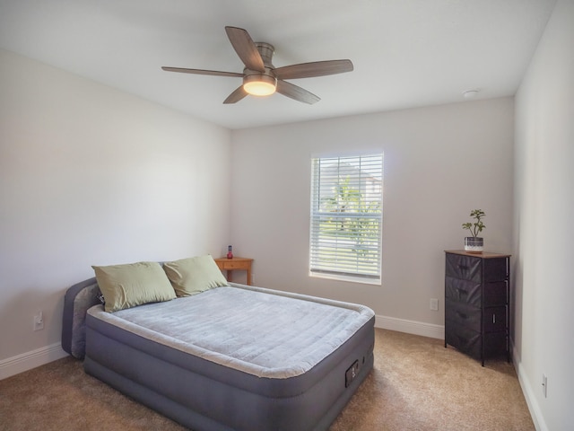 bedroom with light colored carpet and ceiling fan