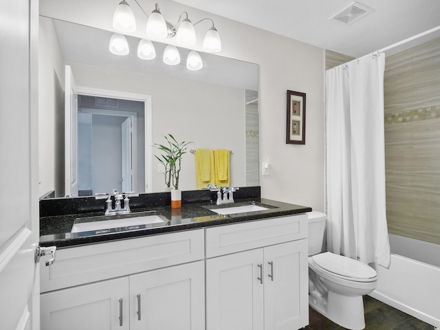 full bathroom featuring vanity, shower / bath combo, and toilet