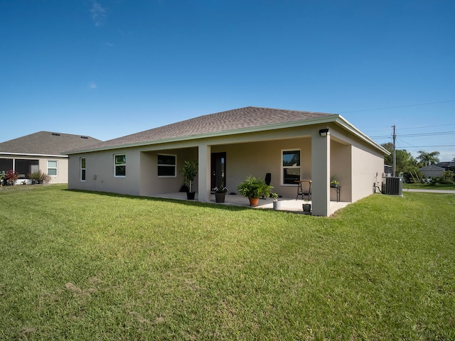 back of property featuring central AC, a patio area, and a lawn