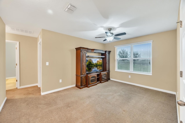 unfurnished living room featuring light carpet and ceiling fan