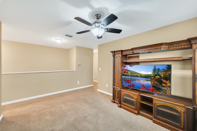 carpeted home theater with ceiling fan