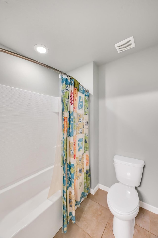 bathroom featuring shower / bath combo with shower curtain, tile patterned flooring, and toilet