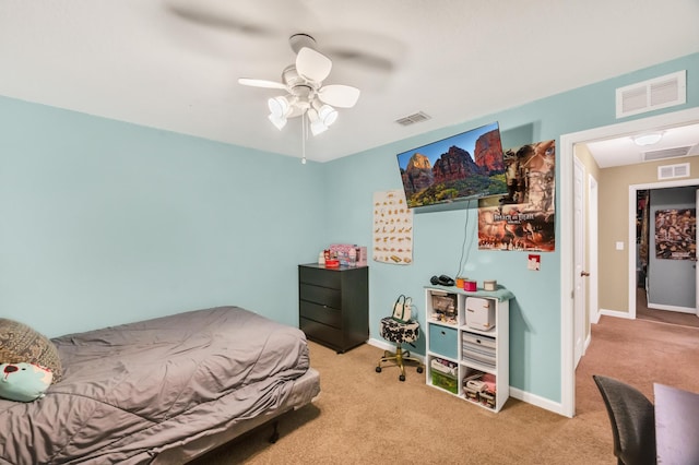 bedroom with ceiling fan and light carpet