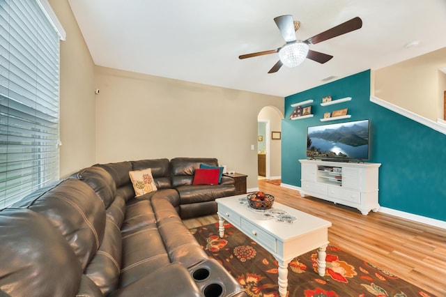 living room featuring ceiling fan and hardwood / wood-style flooring