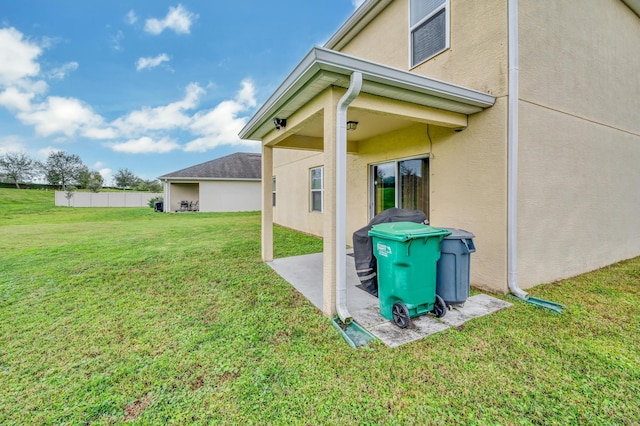 view of side of property with a lawn