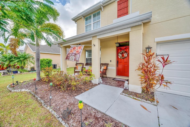 property entrance with covered porch and a yard