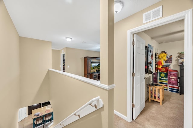 hallway featuring light carpet