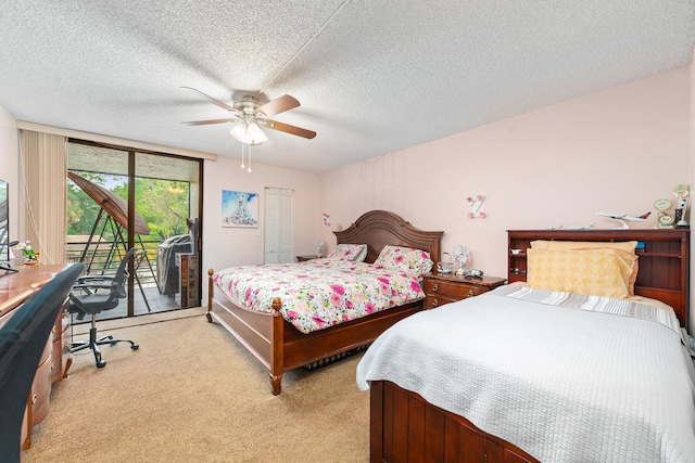 carpeted bedroom featuring a textured ceiling, access to outside, and ceiling fan