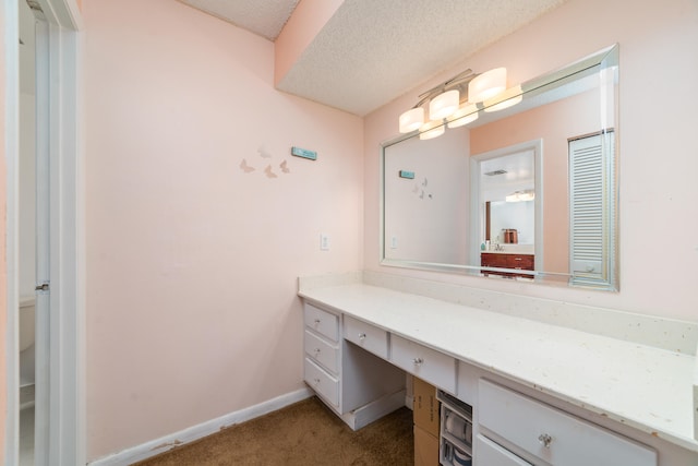 bathroom with vanity and a textured ceiling