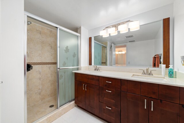 bathroom featuring tile patterned floors, vanity, and a shower with door