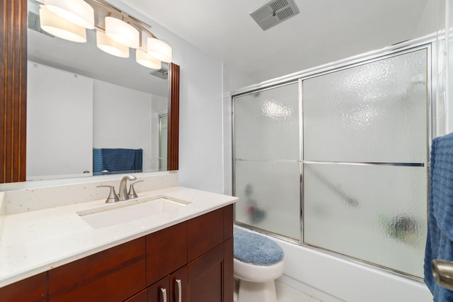 full bathroom featuring vanity, toilet, and enclosed tub / shower combo