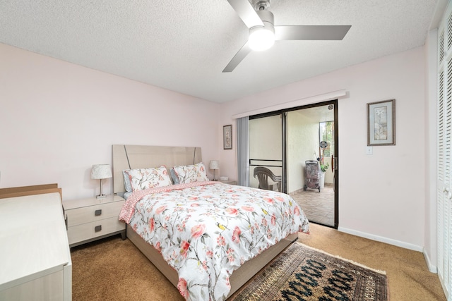 7579 NW 79th Ave Unit 201, Tamarac, FL 33321 - bedroom featuring carpet flooring, a textured ceiling, access to exterior, a ceiling fan, and baseboards