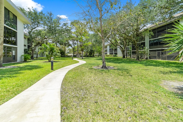 view of property's community with a lawn