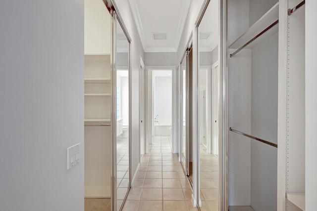 hall featuring ornamental molding and light tile patterned flooring