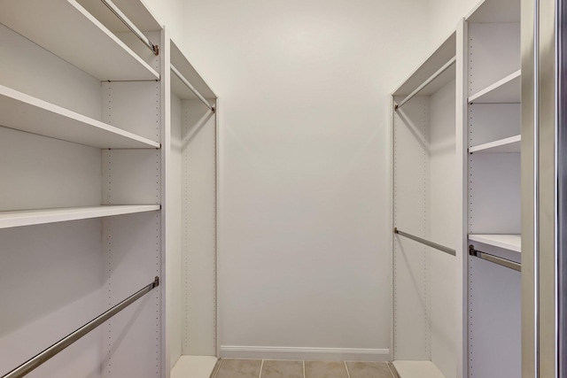 spacious closet with light tile patterned floors