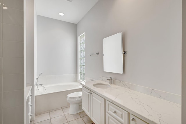 bathroom with toilet, tile patterned floors, a tub to relax in, and vanity