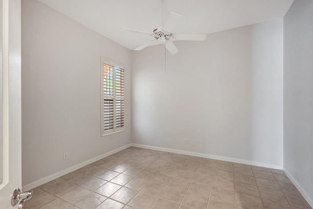 tiled spare room featuring ceiling fan