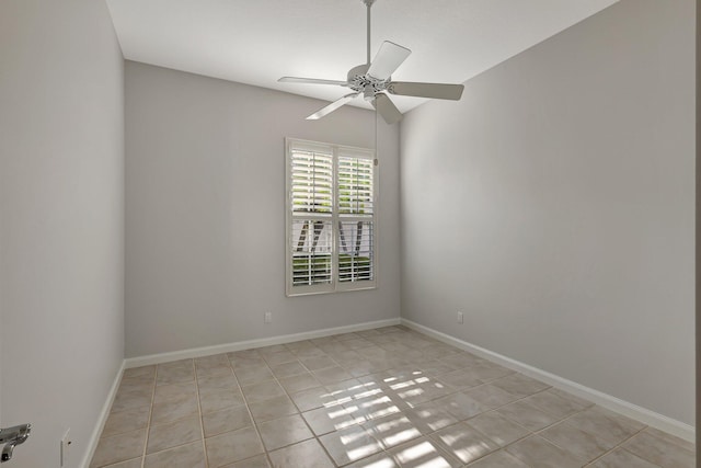 tiled empty room featuring ceiling fan