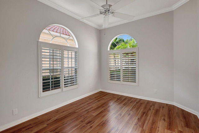 spare room featuring ceiling fan, crown molding, and wood-type flooring