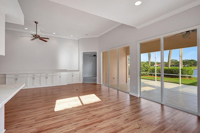 interior space featuring ceiling fan, ornamental molding, and light hardwood / wood-style floors