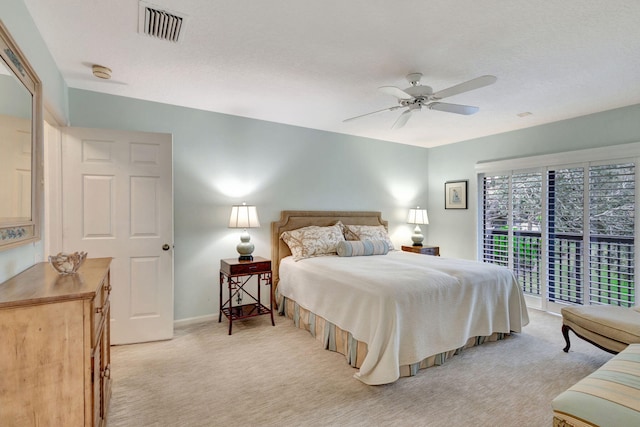 carpeted bedroom with access to exterior, a textured ceiling, and ceiling fan