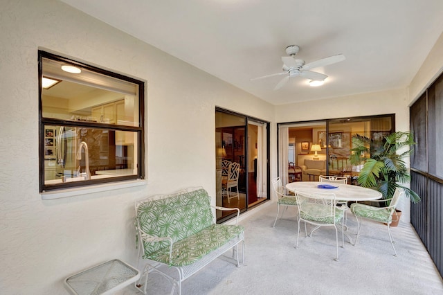 sunroom / solarium with ceiling fan and sink