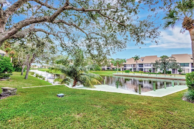 view of community with a water view and a yard