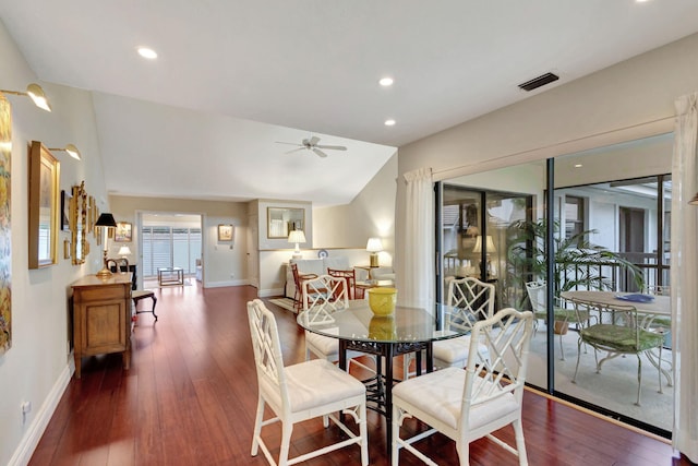 dining space featuring ceiling fan, dark wood-type flooring, and vaulted ceiling