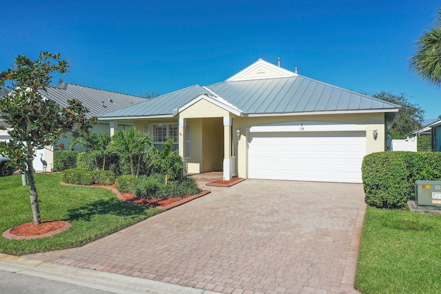 view of front of property with a front yard, a garage, and central AC unit