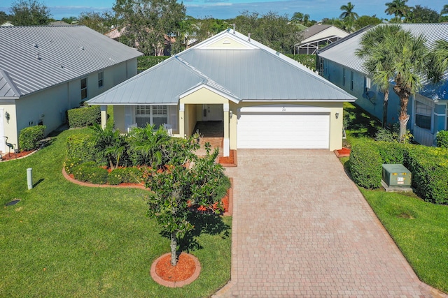 view of front of house with a garage and a front lawn