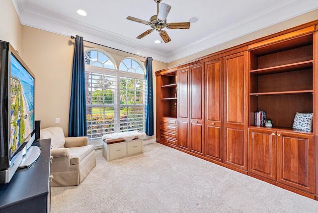 sitting room featuring light carpet, crown molding, and ceiling fan