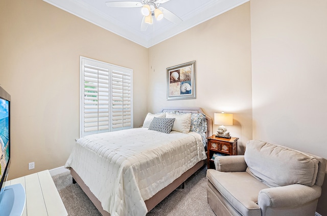 carpeted bedroom featuring ceiling fan and ornamental molding