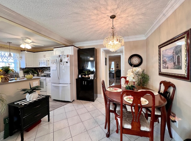 dining space with light tile patterned flooring, ornamental molding, and a textured ceiling