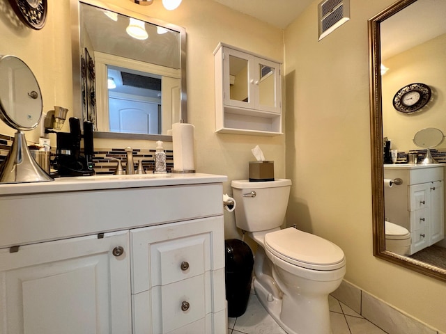 bathroom featuring tile patterned floors, vanity, and toilet