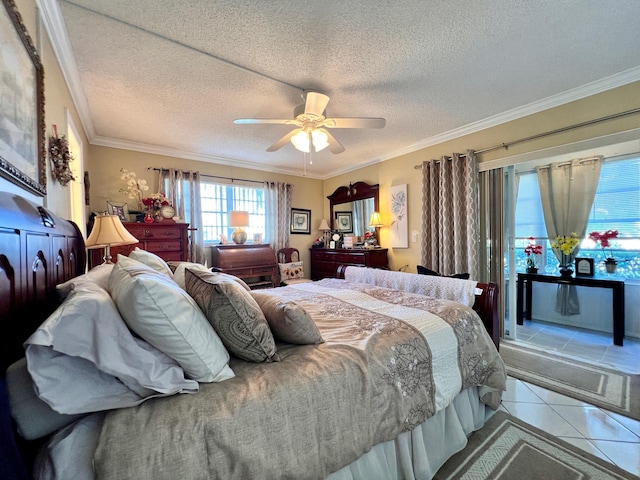 tiled bedroom with ceiling fan, a textured ceiling, and ornamental molding