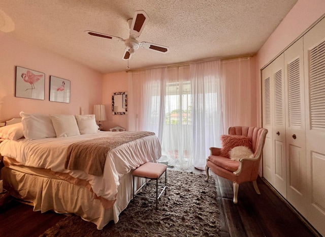 bedroom featuring a textured ceiling, a closet, ceiling fan, and dark wood-type flooring