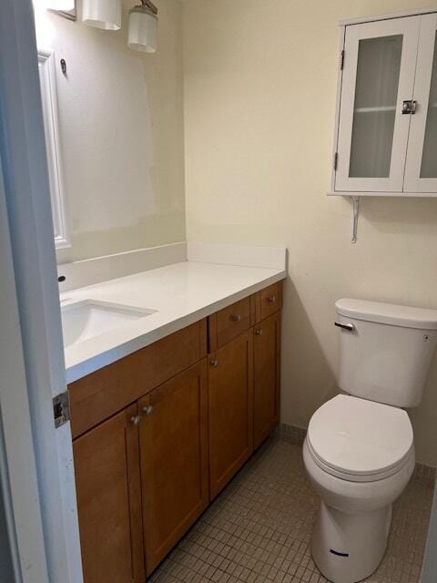 bathroom featuring tile patterned flooring, vanity, and toilet