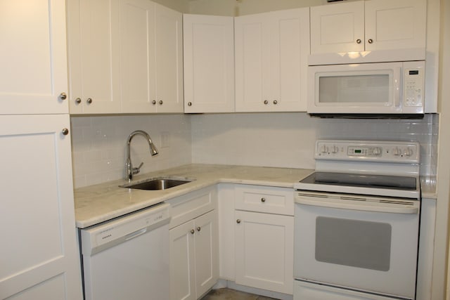 kitchen featuring white cabinets, backsplash, white appliances, and sink