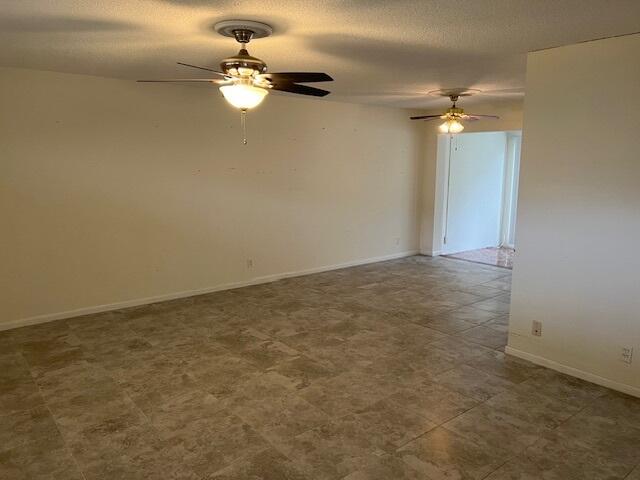 unfurnished room featuring ceiling fan and a textured ceiling